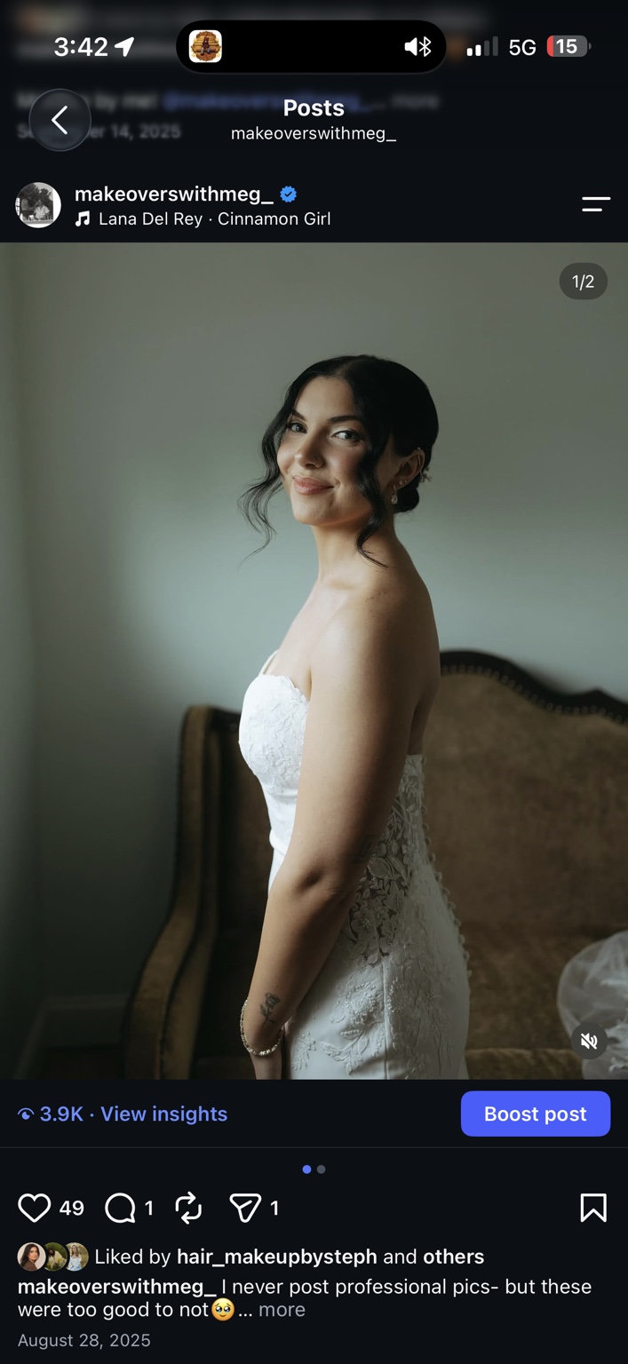 Bride in a lace dress with softly defined makeup and a romantic dark updo
