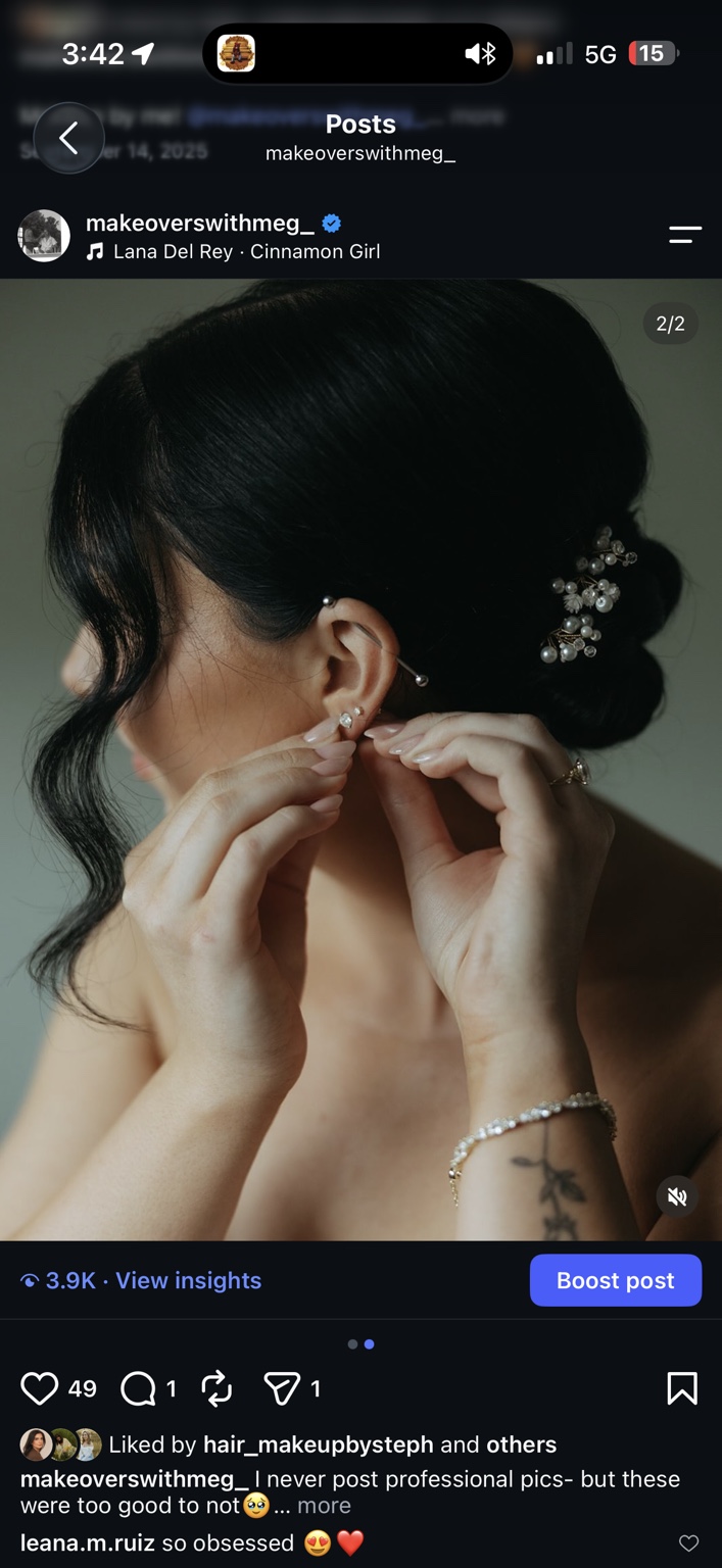 Close view of a dark bridal updo with pearl accessories