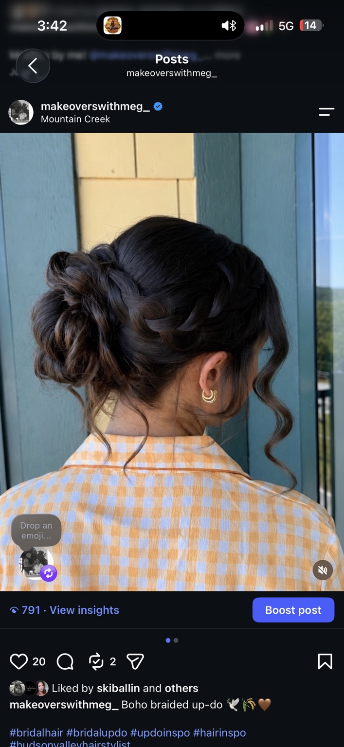 Textured braided brunette updo with soft face-framing pieces