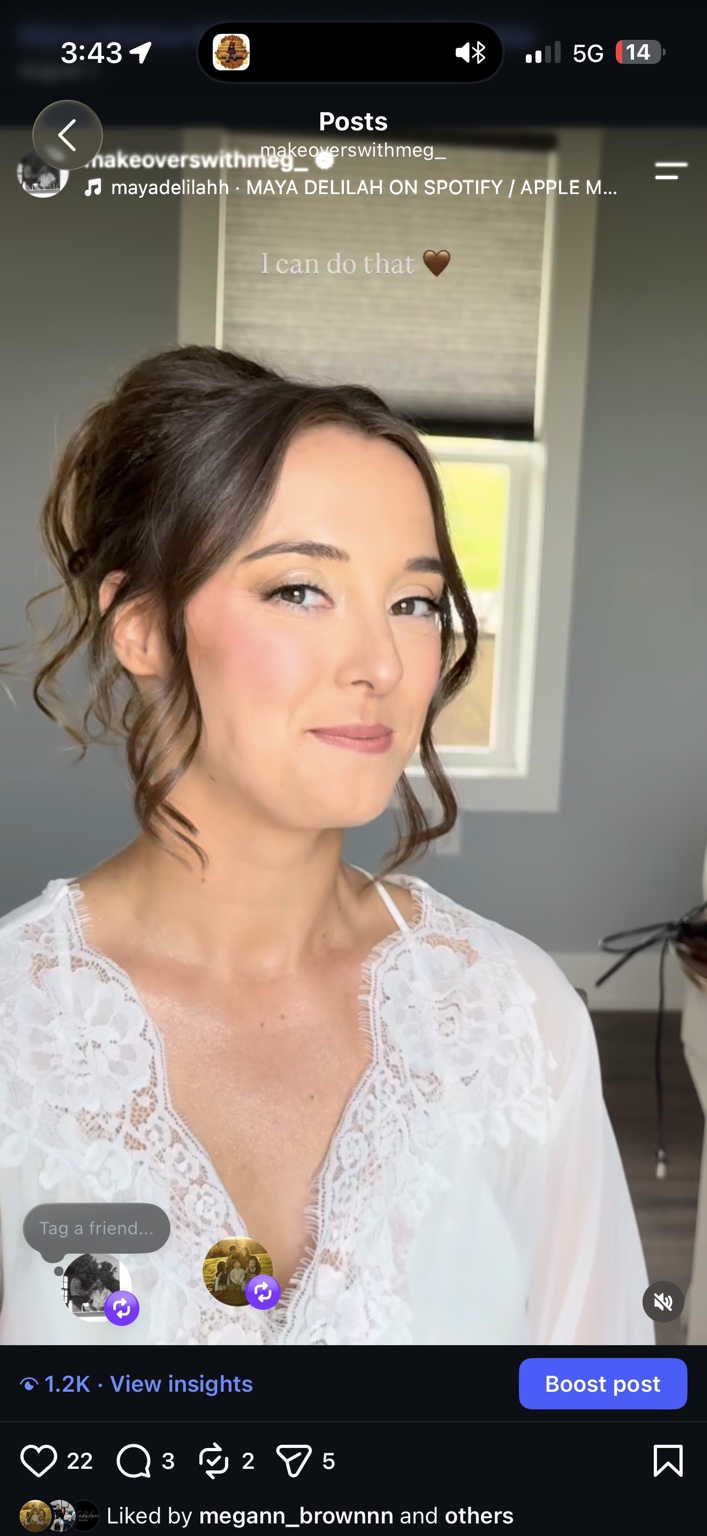 Bride wearing rosy makeup and a softly swept updo