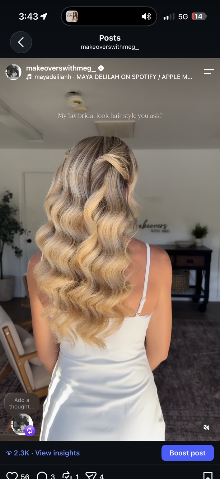 Long blonde hair styled in polished cascading waves